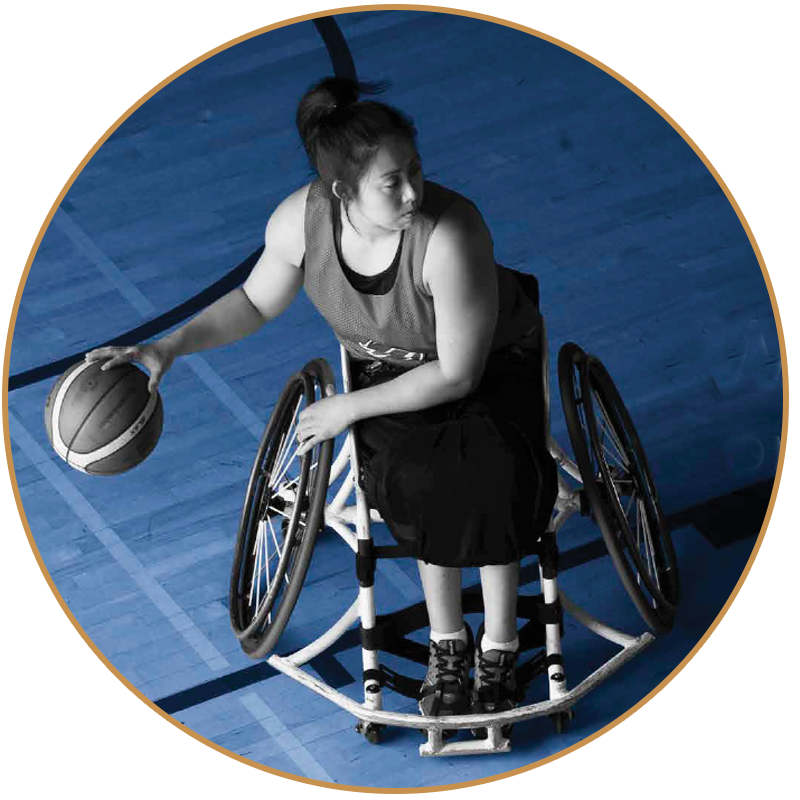girl in wheelchair playing baseketball